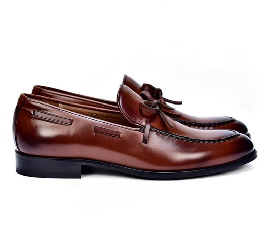 Pair of brown leather loafers on a white background