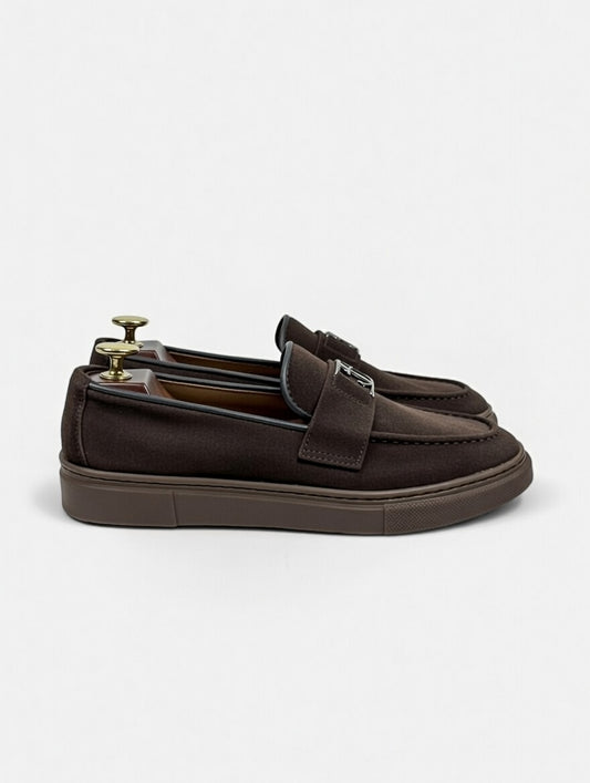 Brown loafers with a bow on a white background