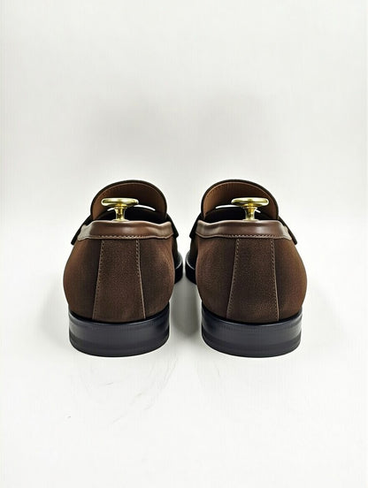 Pair of brown loafers on a white background