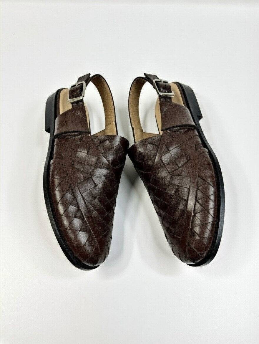 Pair of brown woven loafers on a white background