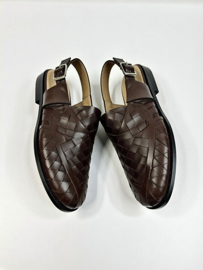 Pair of brown woven loafers on a white background