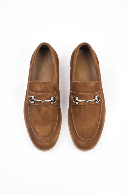 Pair of brown suede loafers with metallic embellishments on a white background