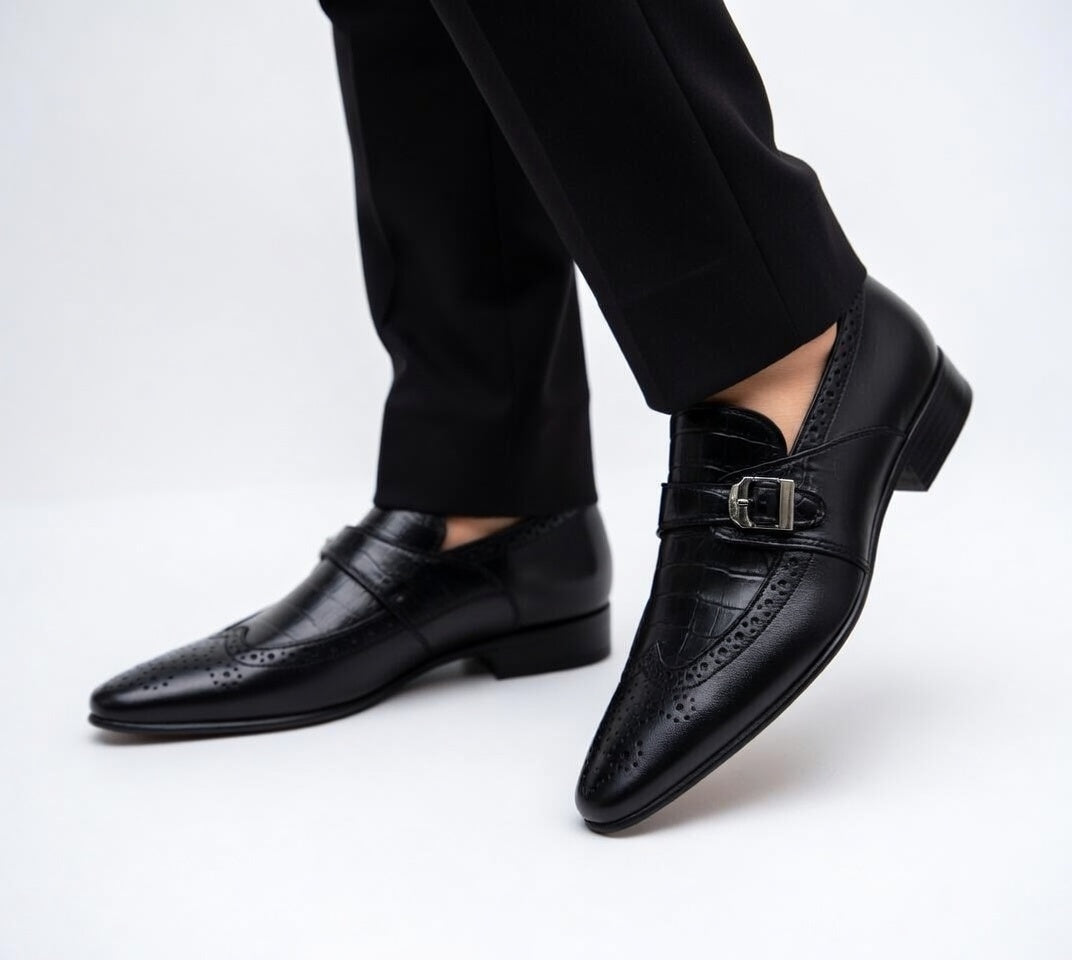 Black dress shoes with a buckle on a white background