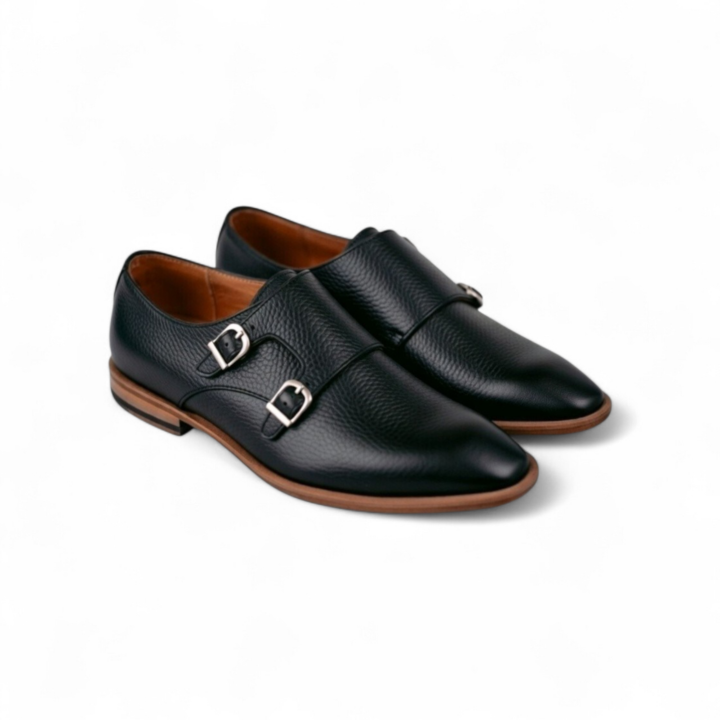 Pair of black leather shoes with brown soles on a white background
