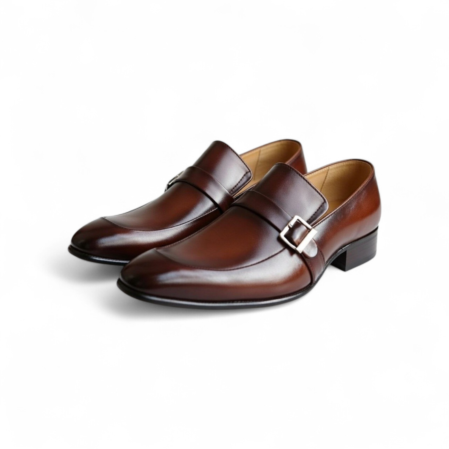 Pair of brown leather shoes with buckles on a white background