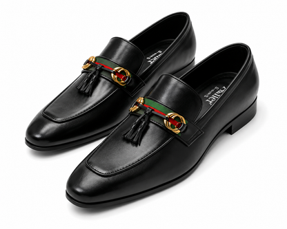 A pair of black leather Gucci loafers with the brand's signature green and red web stripe and gold-tone horsebit hardware, displayed on a clean white background.