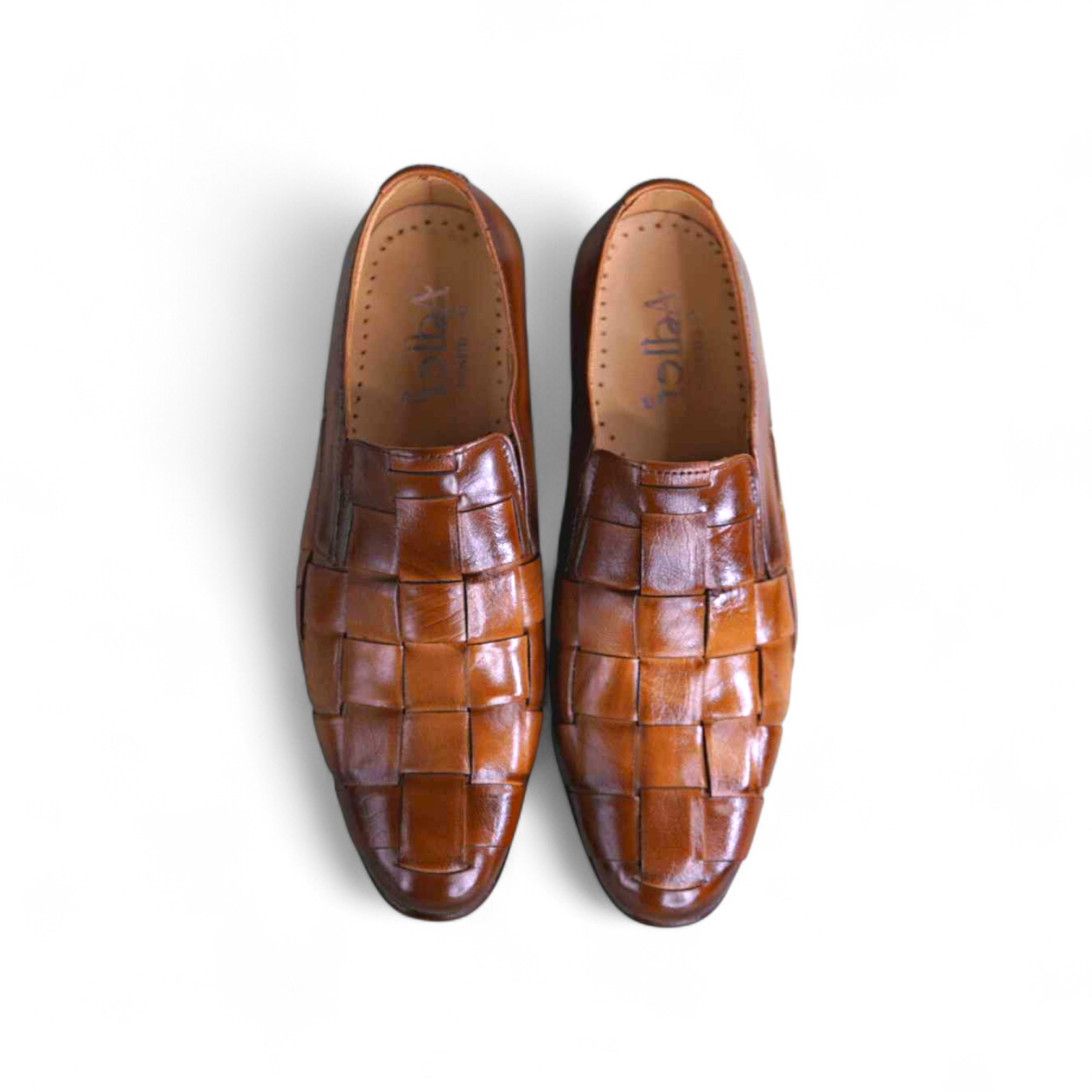 Pair of brown woven loafers on a white background