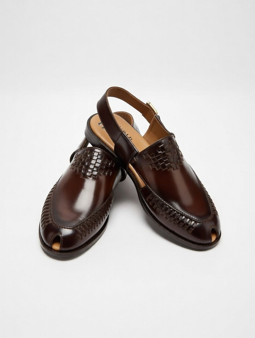 Pair of brown leather shoes on a light gray background
