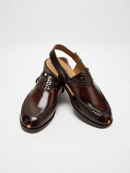 Pair of brown leather shoes on a light gray background