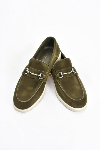 Pair of olive green loafers with metallic buckles on a white background