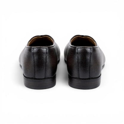 A pair of dark brown pebbled leather dress shoes shown from the rear on a white background.