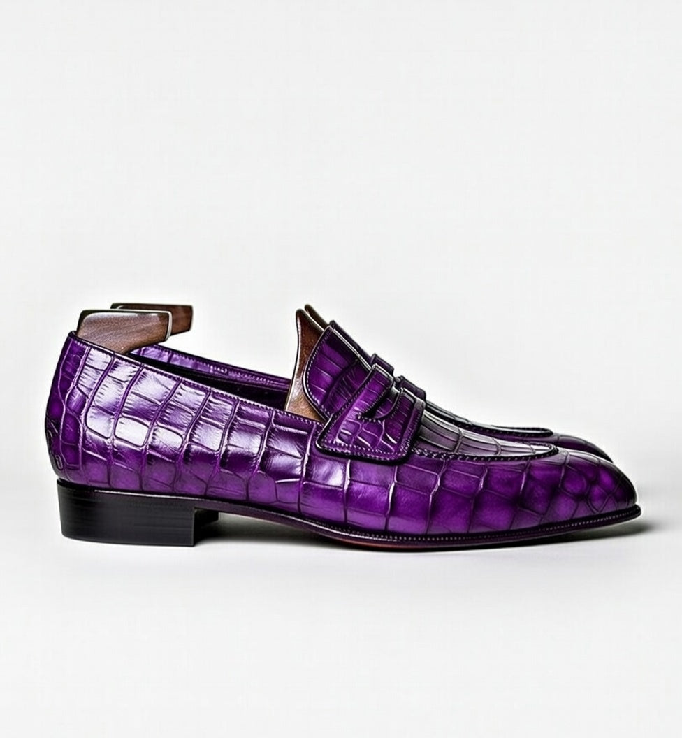 Purple crocodile-patterned loafer shoe on a white background