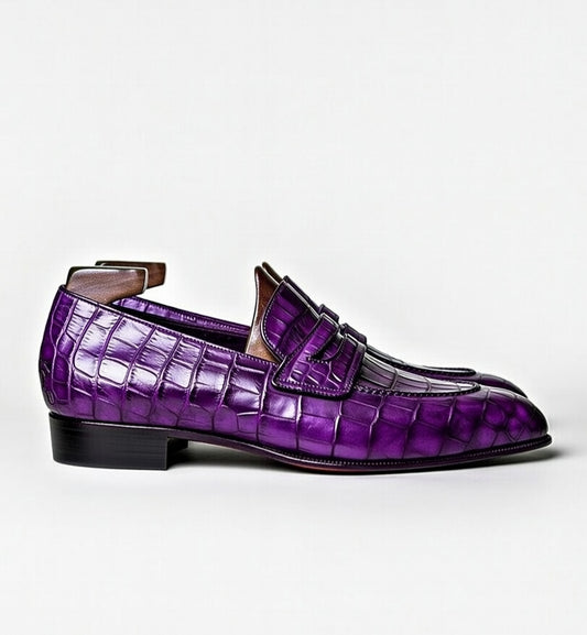 Purple crocodile-patterned loafer shoe on a white background