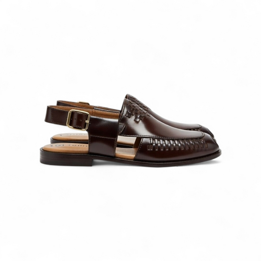 Brown leather sandals with a buckle on a white background