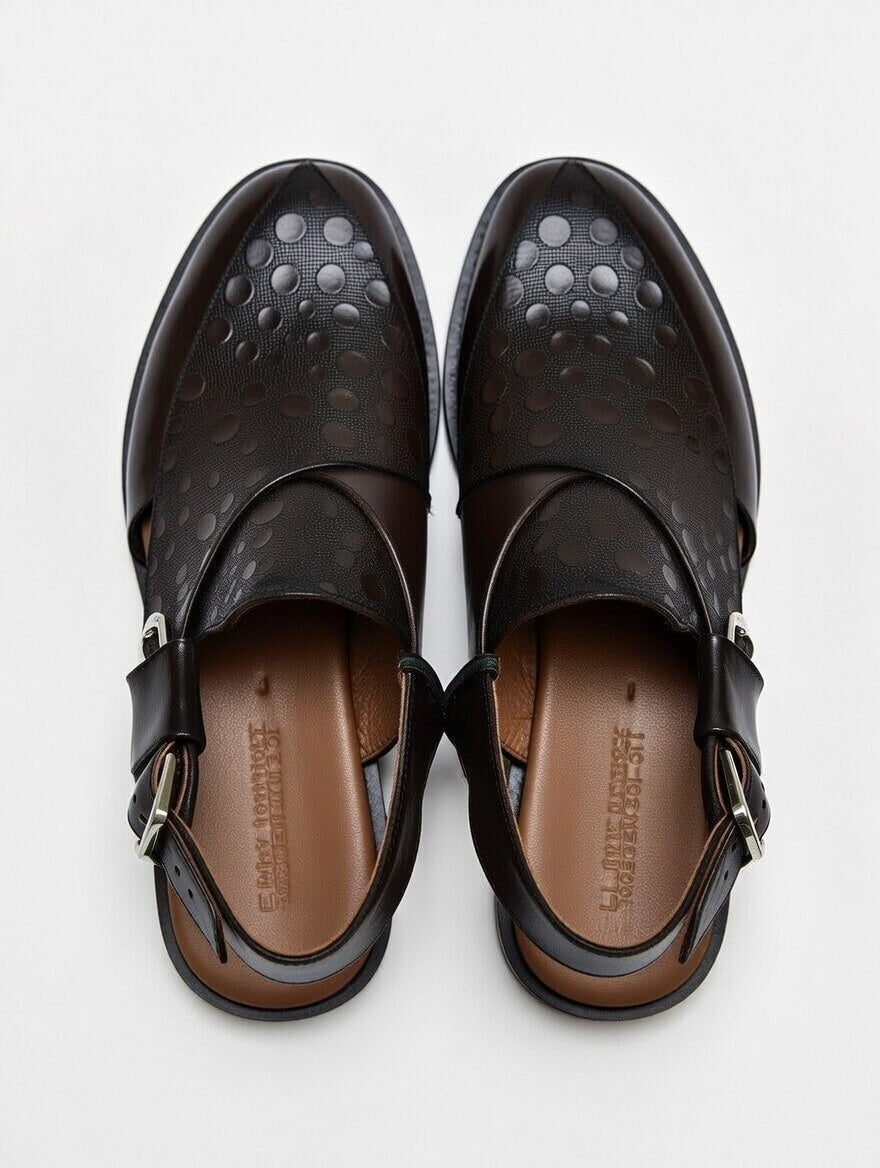 Pair of black sandals with a buckle on a white background