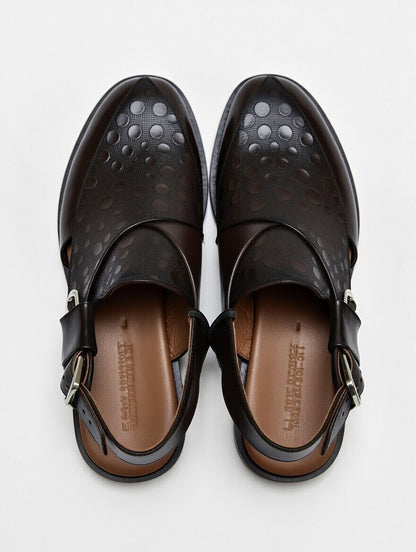 Pair of black sandals with a buckle on a white background