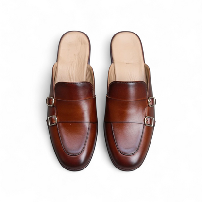 Pair of brown leather loafers on a white background