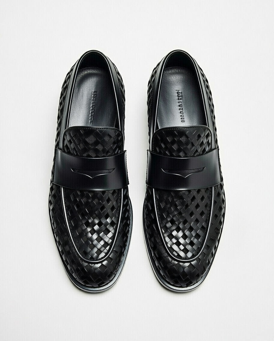 Black woven loafers on a light gray background