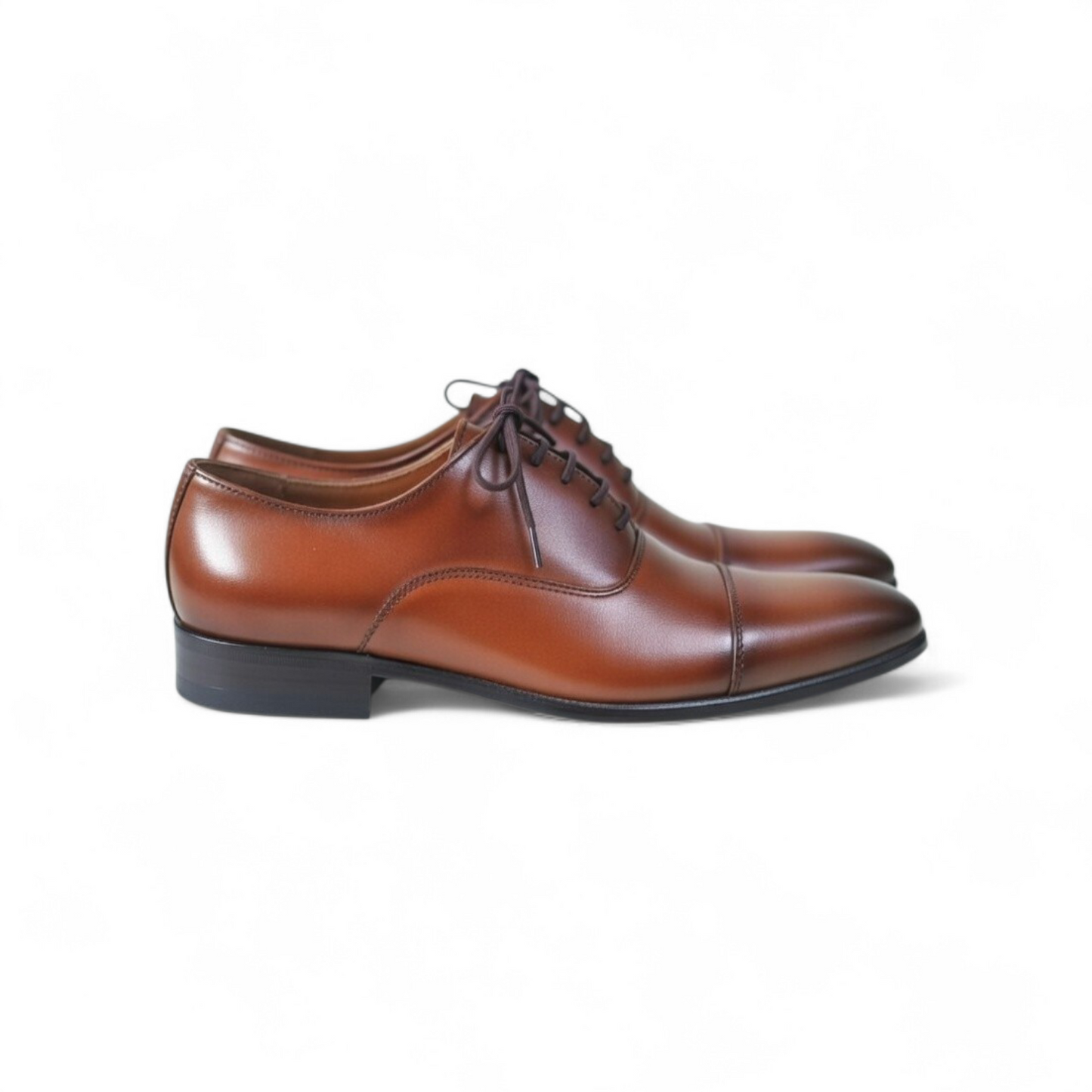 Brown leather dress shoes on a white background