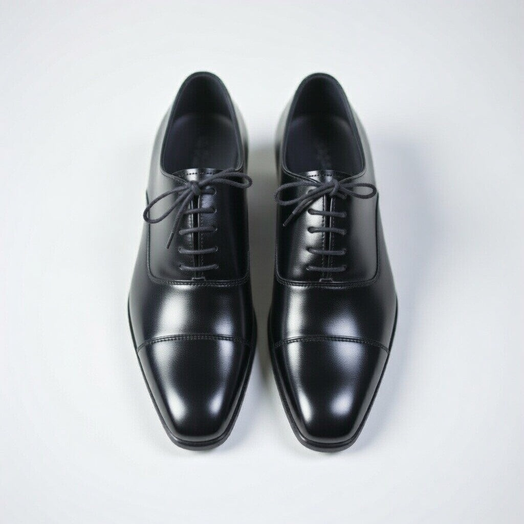 Pair of black dress shoes on a white background