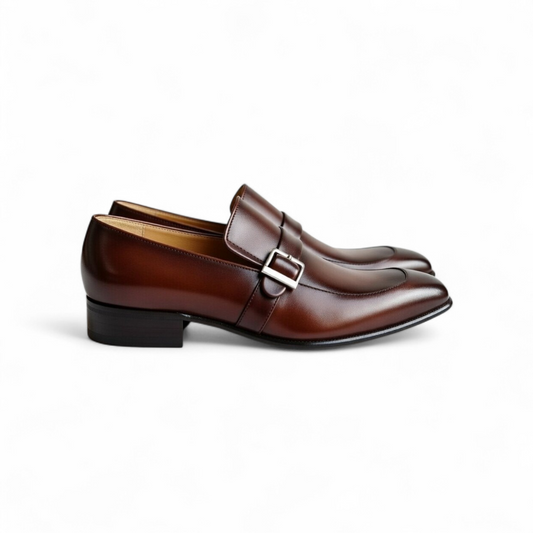 Pair of brown leather loafers with a buckle on a white background