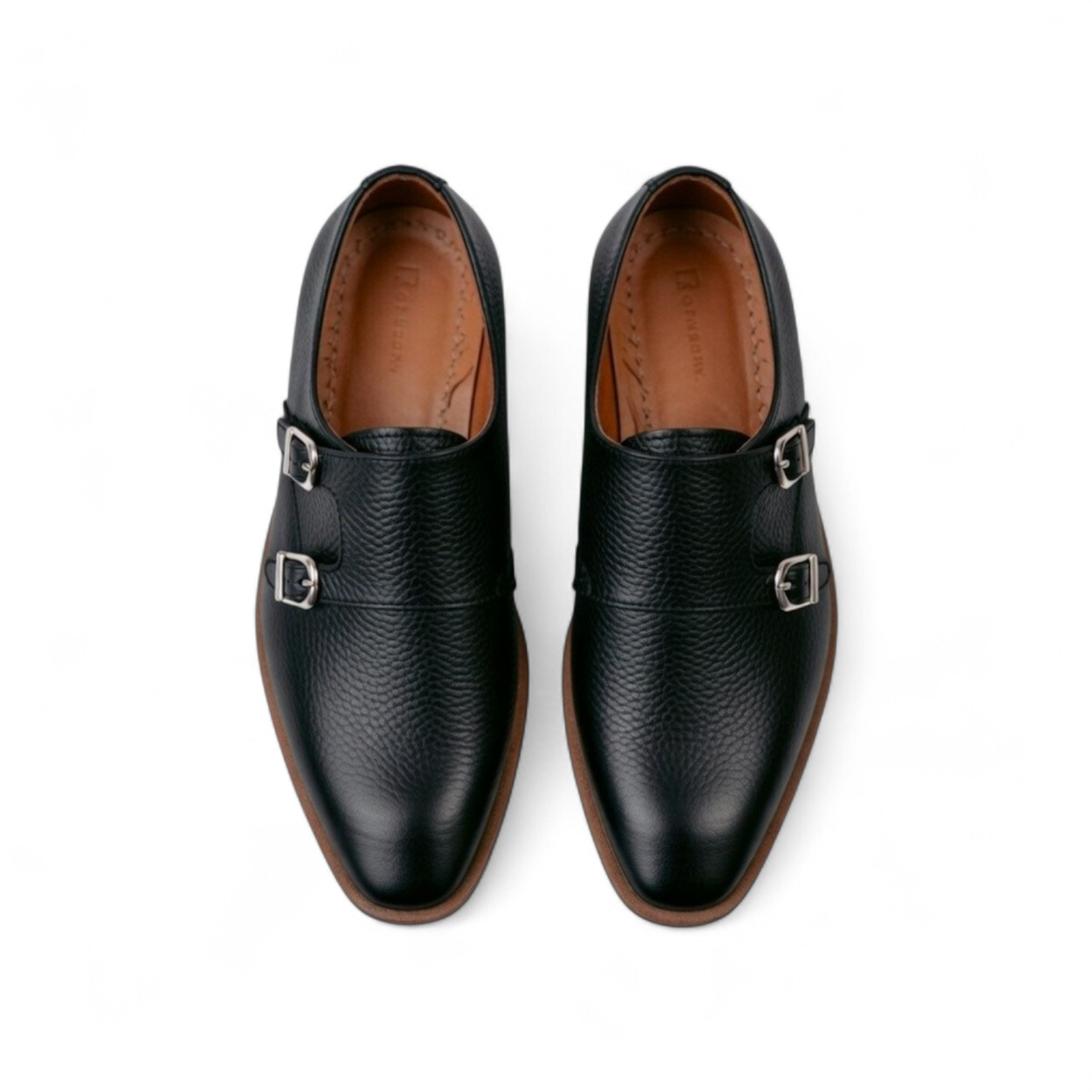 Pair of black leather shoes with buckles on a white background