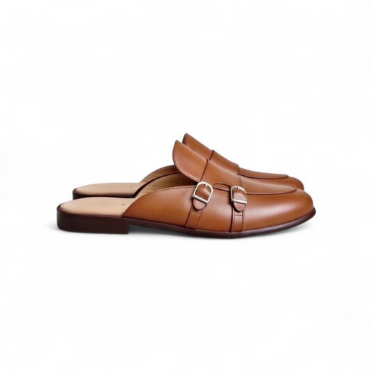Pair of brown leather mules with buckles on a white background