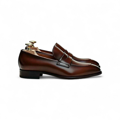 Brown leather shoes with a polished finish on a white background
