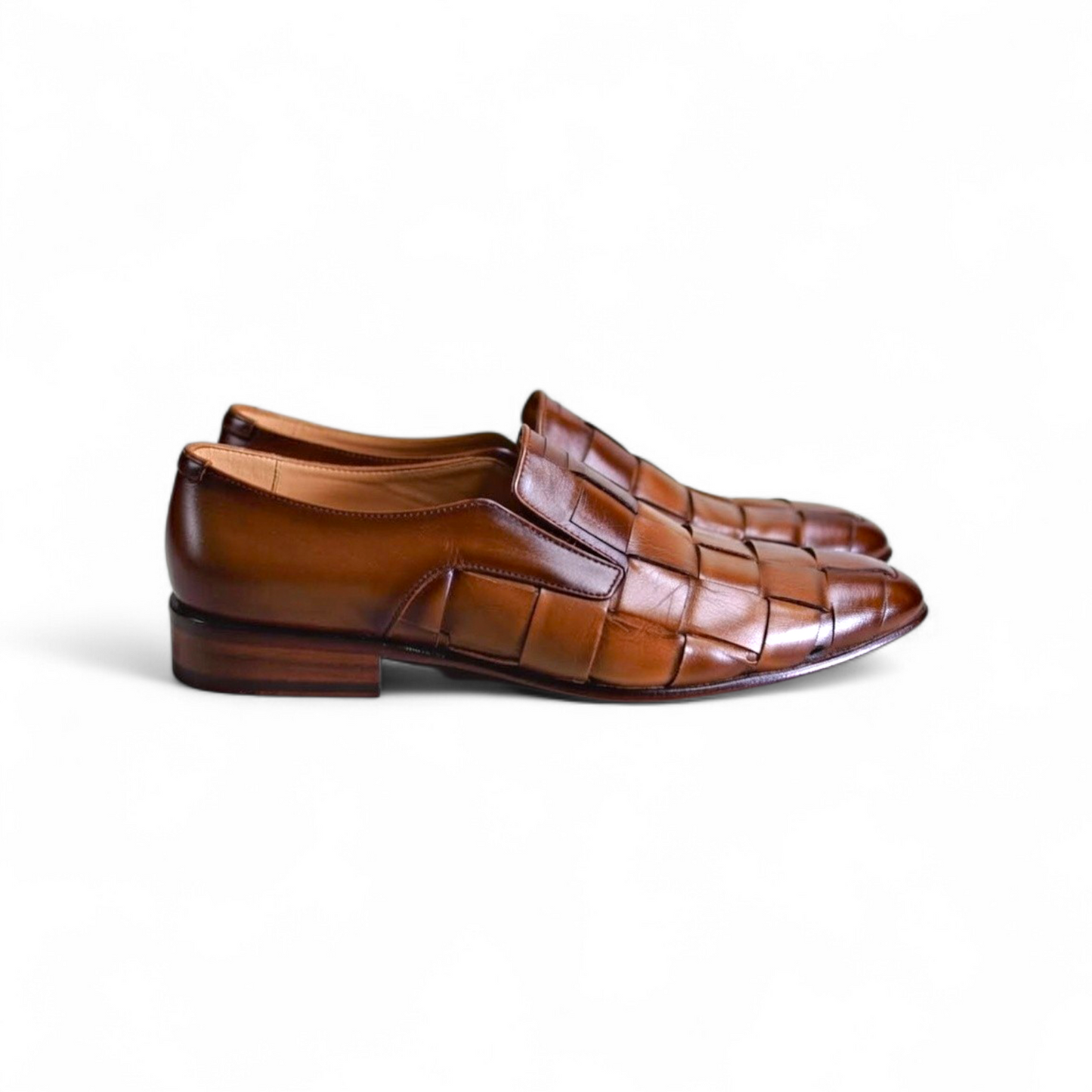 Pair of brown woven dress shoes on a white background