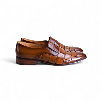 Pair of brown woven dress shoes on a white background