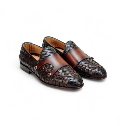 Pair of brown and black woven loafers on a white background