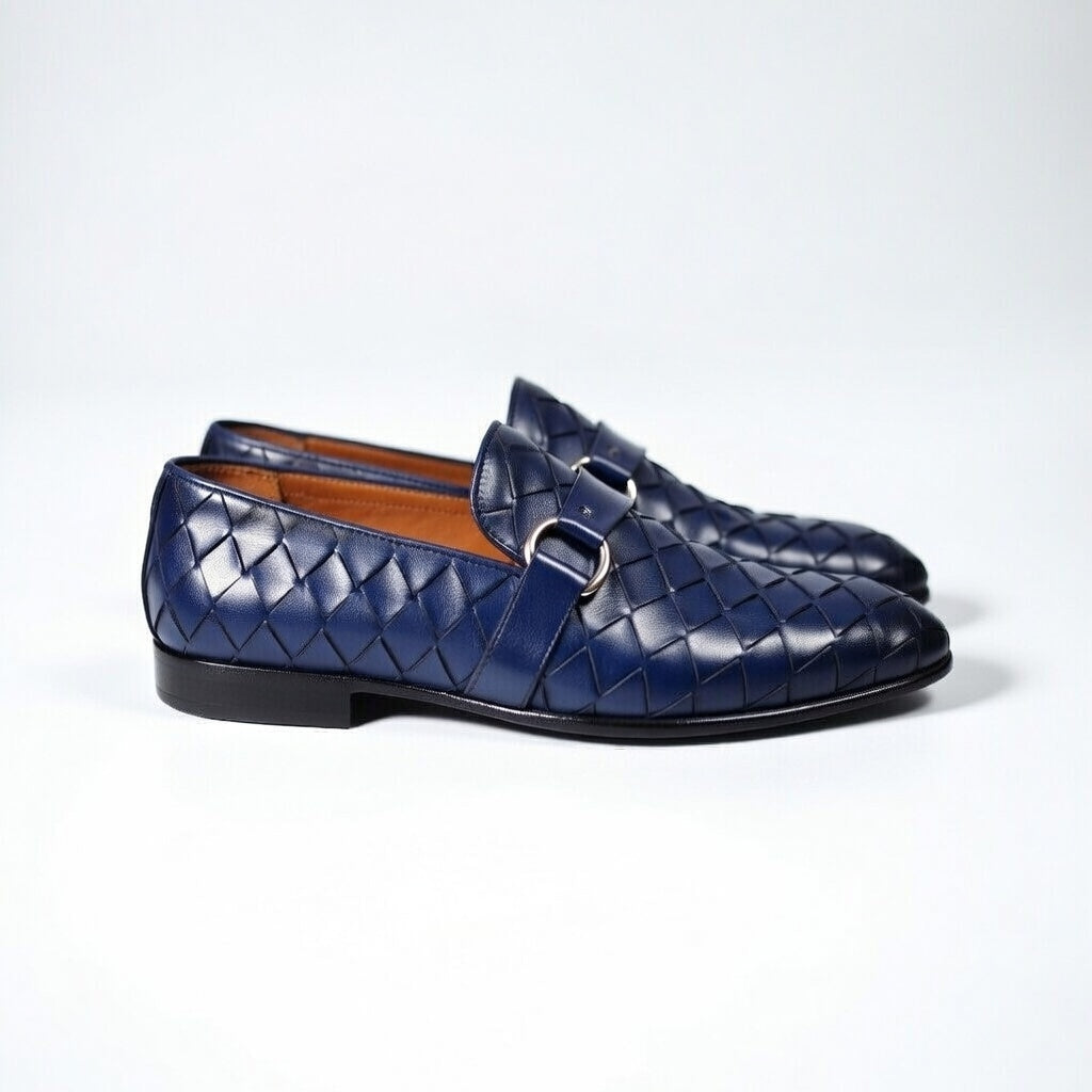 Pair of blue woven loafers on a white background