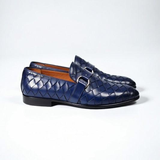 Pair of blue woven loafers on a white background