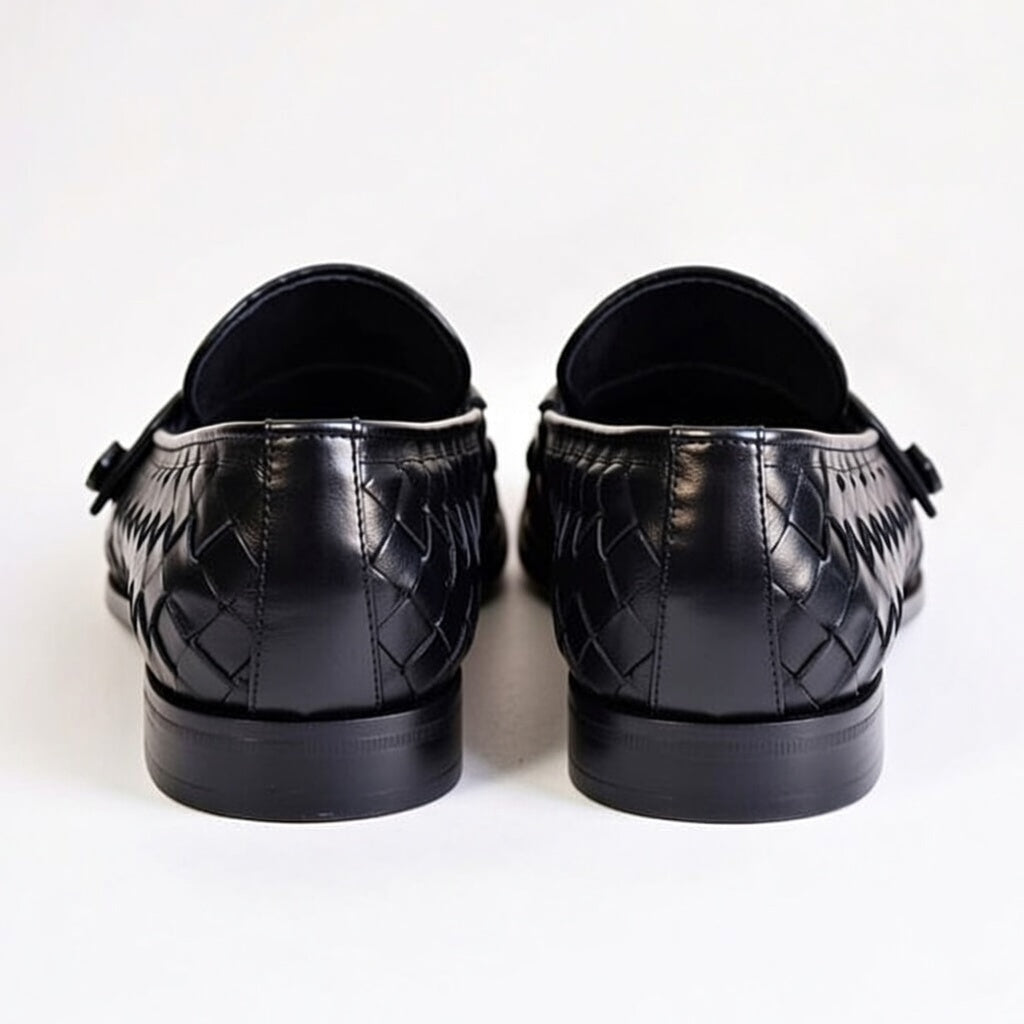 Pair of black leather shoes on a white background