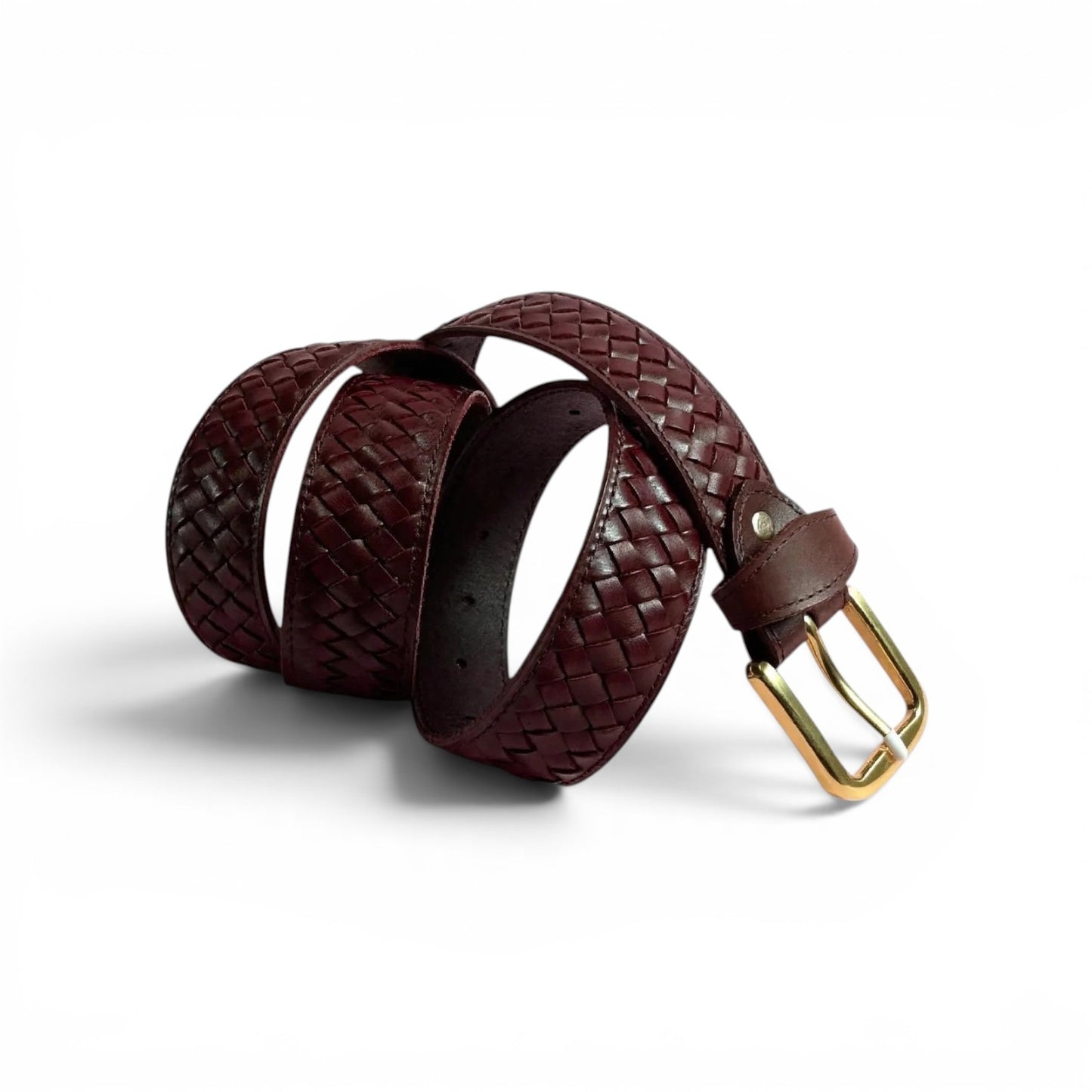 A dark burgundy woven leather belt with a gold buckle, coiled on a white background.