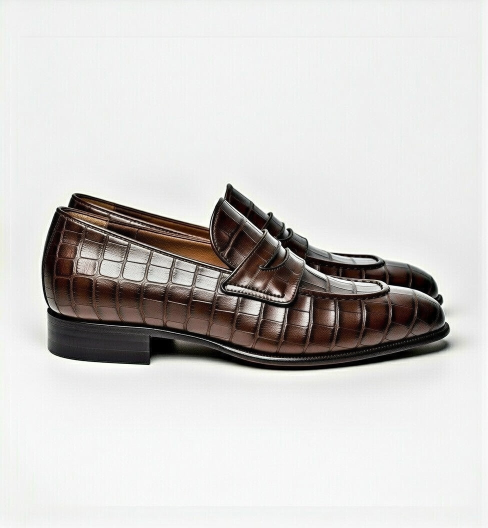 Brown loafers with a textured pattern on a white background