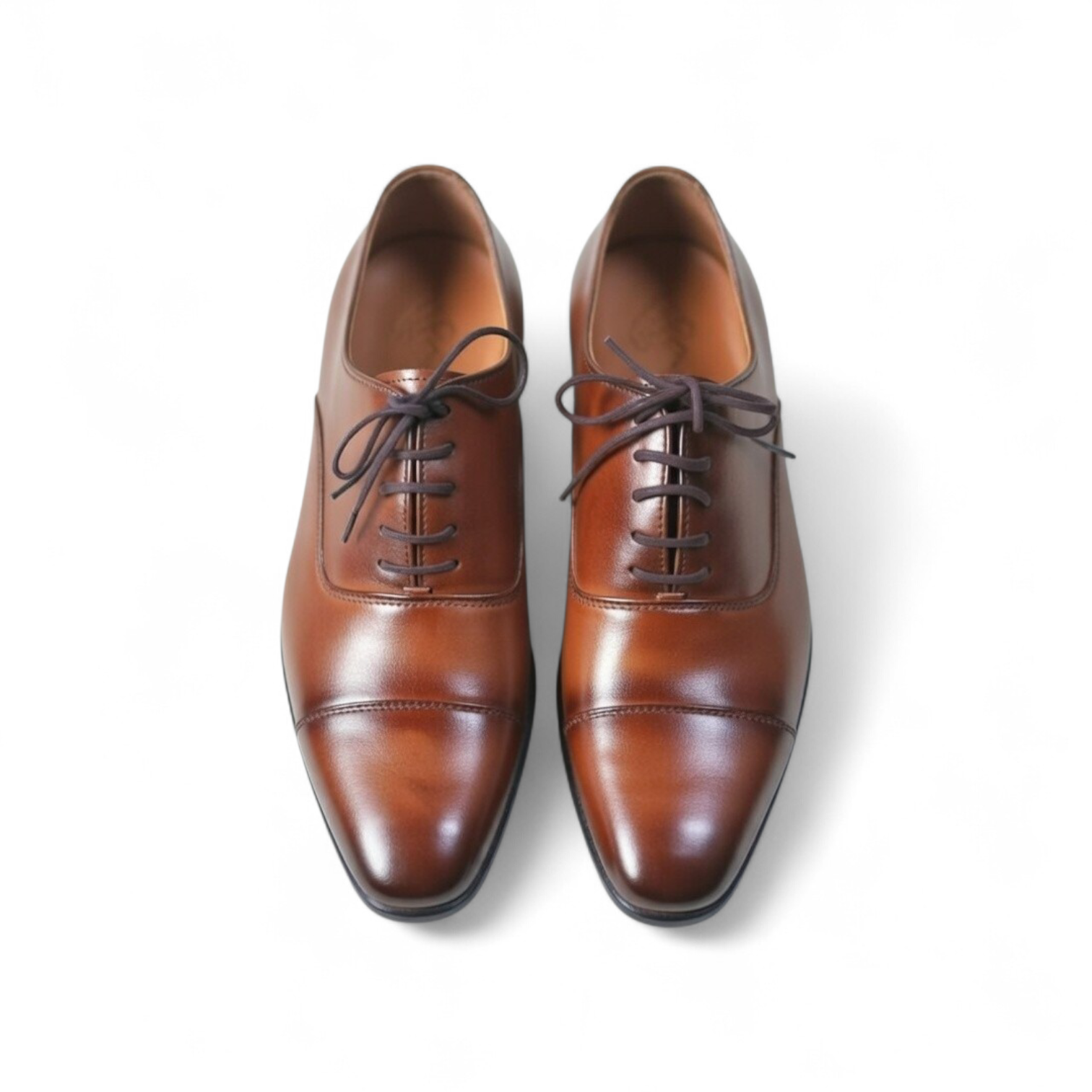 Pair of brown leather dress shoes on a white background