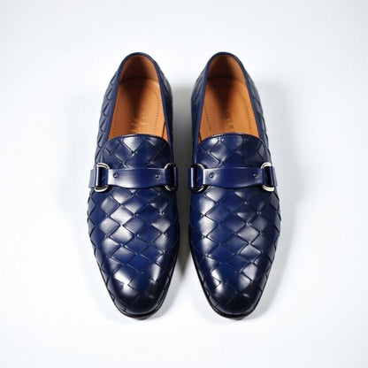 Pair of blue woven loafers on a white background