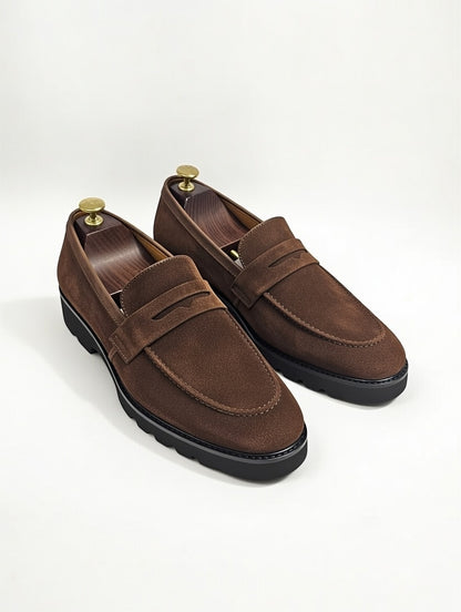 Pair of brown loafers on a white background