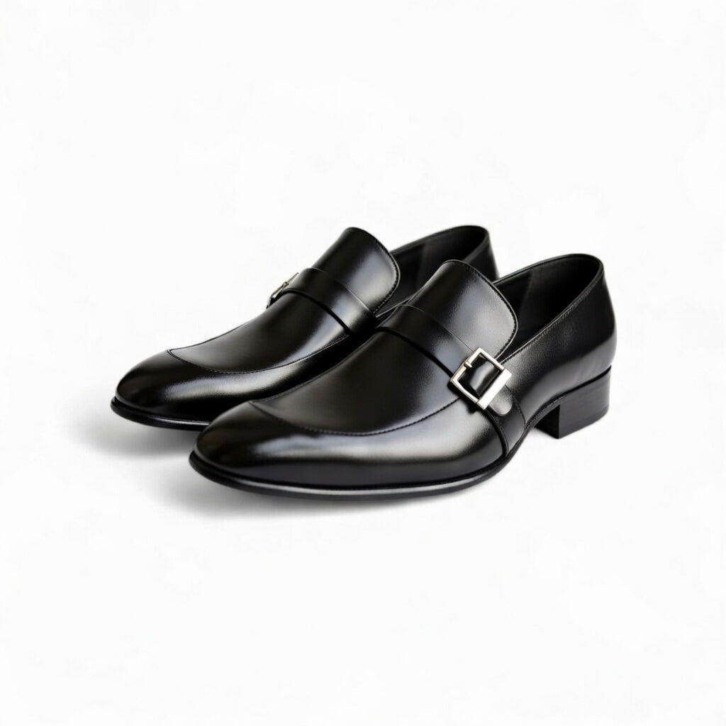Pair of black dress shoes with buckles on a white background