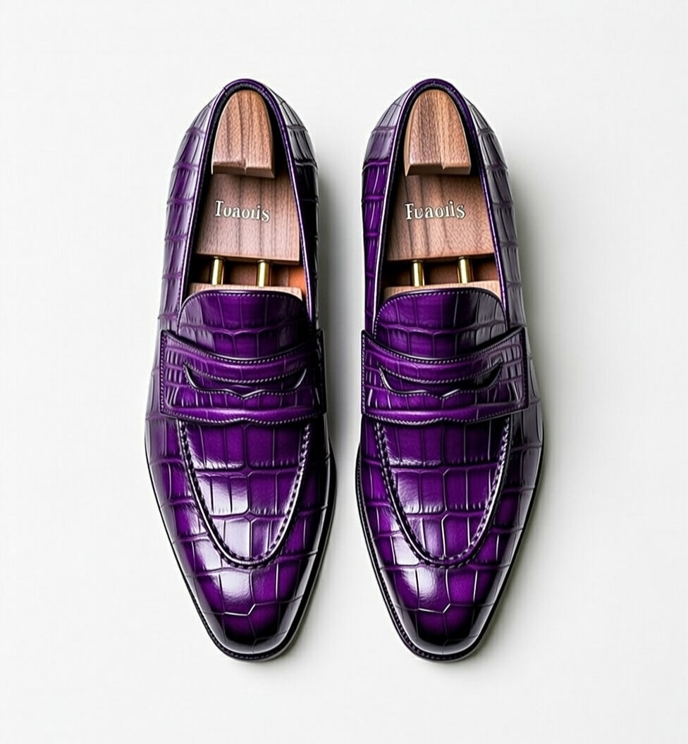 Purple crocodile-patterned loafers on a light gray background