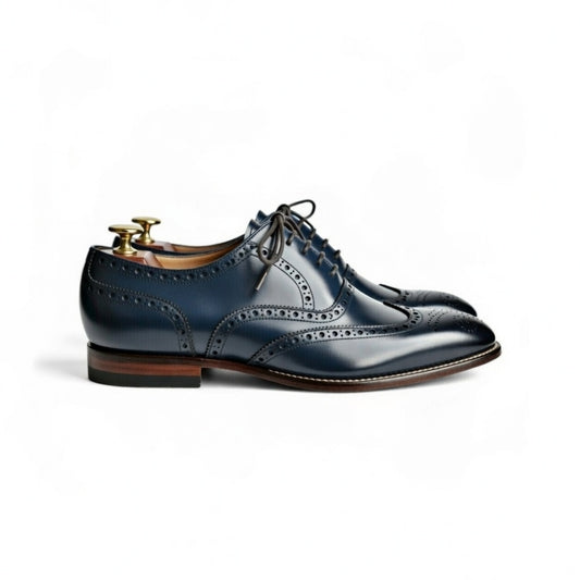 Pair of blue leather dress shoes on a white background