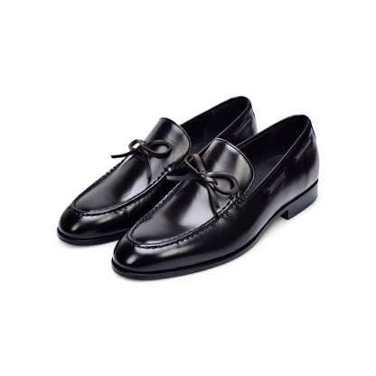 Pair of black dress shoes on a white background