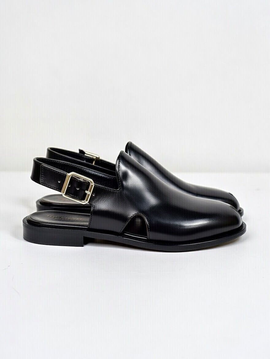 Black leather shoes with a buckle on a white background