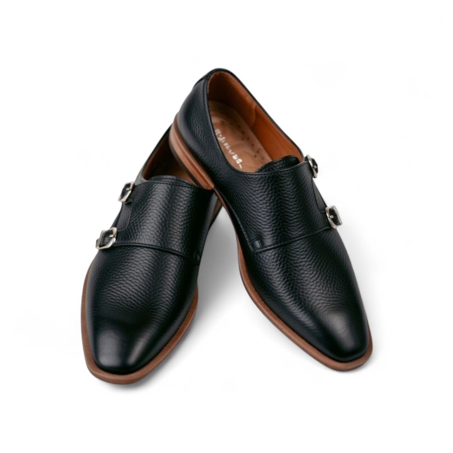 Pair of black leather shoes with brown soles on a white background