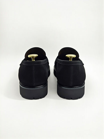 Black shoes with gold accents on a white background